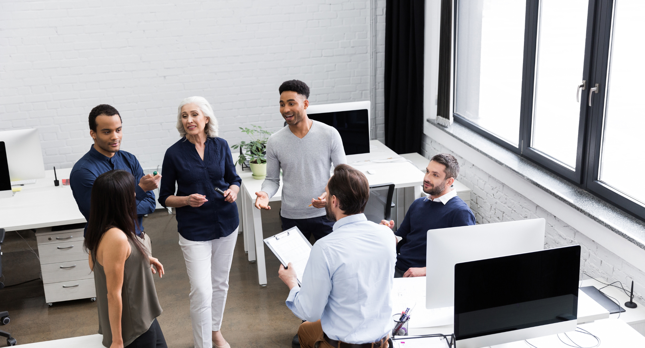 Photo of a team working in a modern environment, using digital devices and collaborating remotely. Digital Transformation